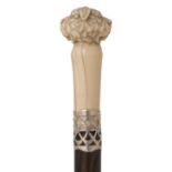 A LATE 19TH CENTURY WALKING CANE, the ivory pommel carved as a double headed dog, white metal