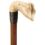 A LATE 19TH CENTURY WALKING CANE, the ivory handle carved as an orchid bloom, above silver collar