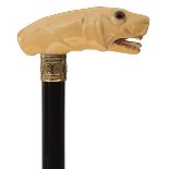 A 19TH CENTURY WALKING CANE, the ivory handle carved as the head of a hunting dog with glass eyes