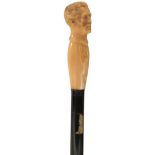 A 19TH CENTURY WALKING CANE, the ivory handle carved as the head of Arthur Wellesley, Duke of