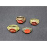 4 Roman Gemstone rings , bronze with decorated sides different finger slices with verdigris in the