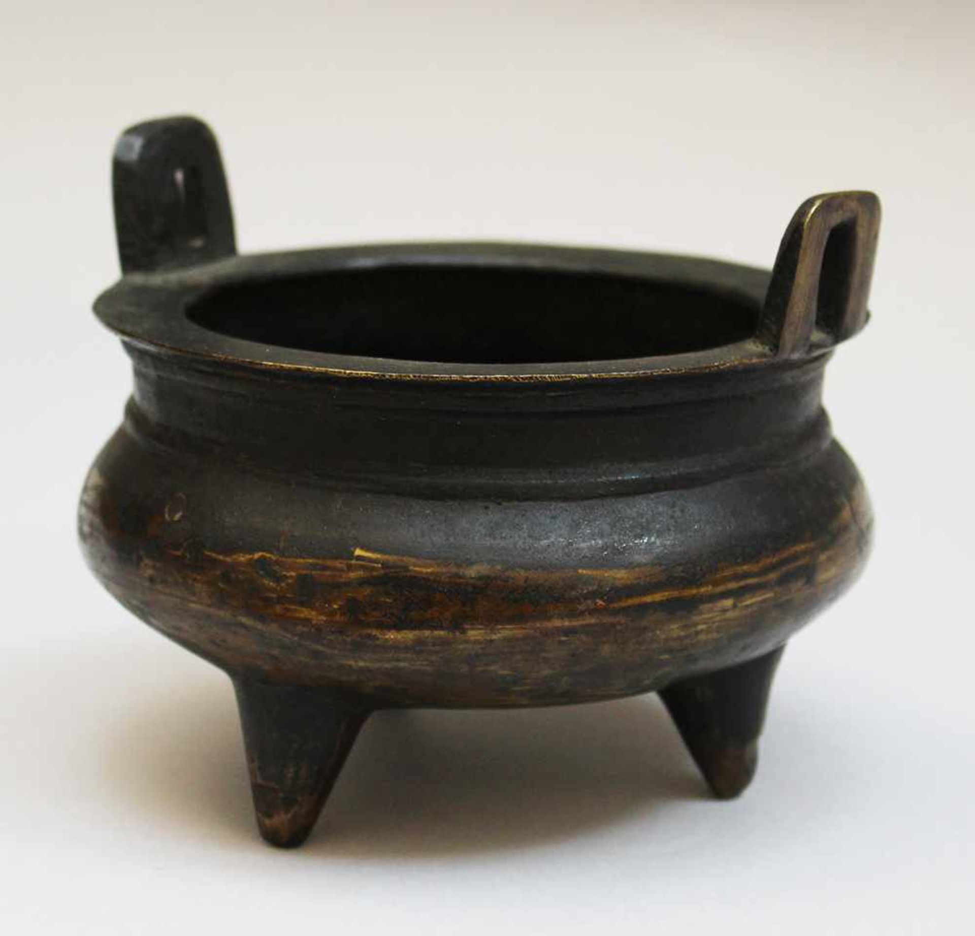 Asian bronze vessel on three legs round bowed bowl with two side-grips. On the underside side, six