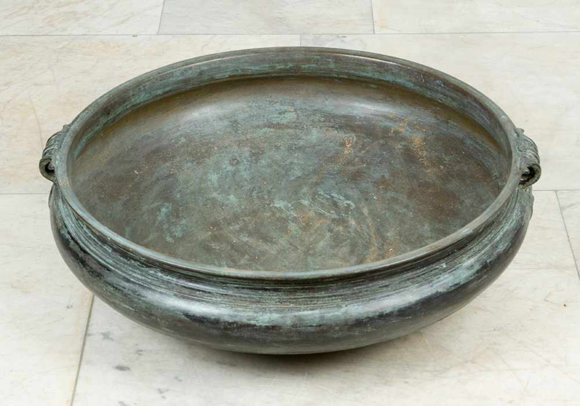 Large bronze bowl. Round bow shape with thinner neck and two open work side-grips with