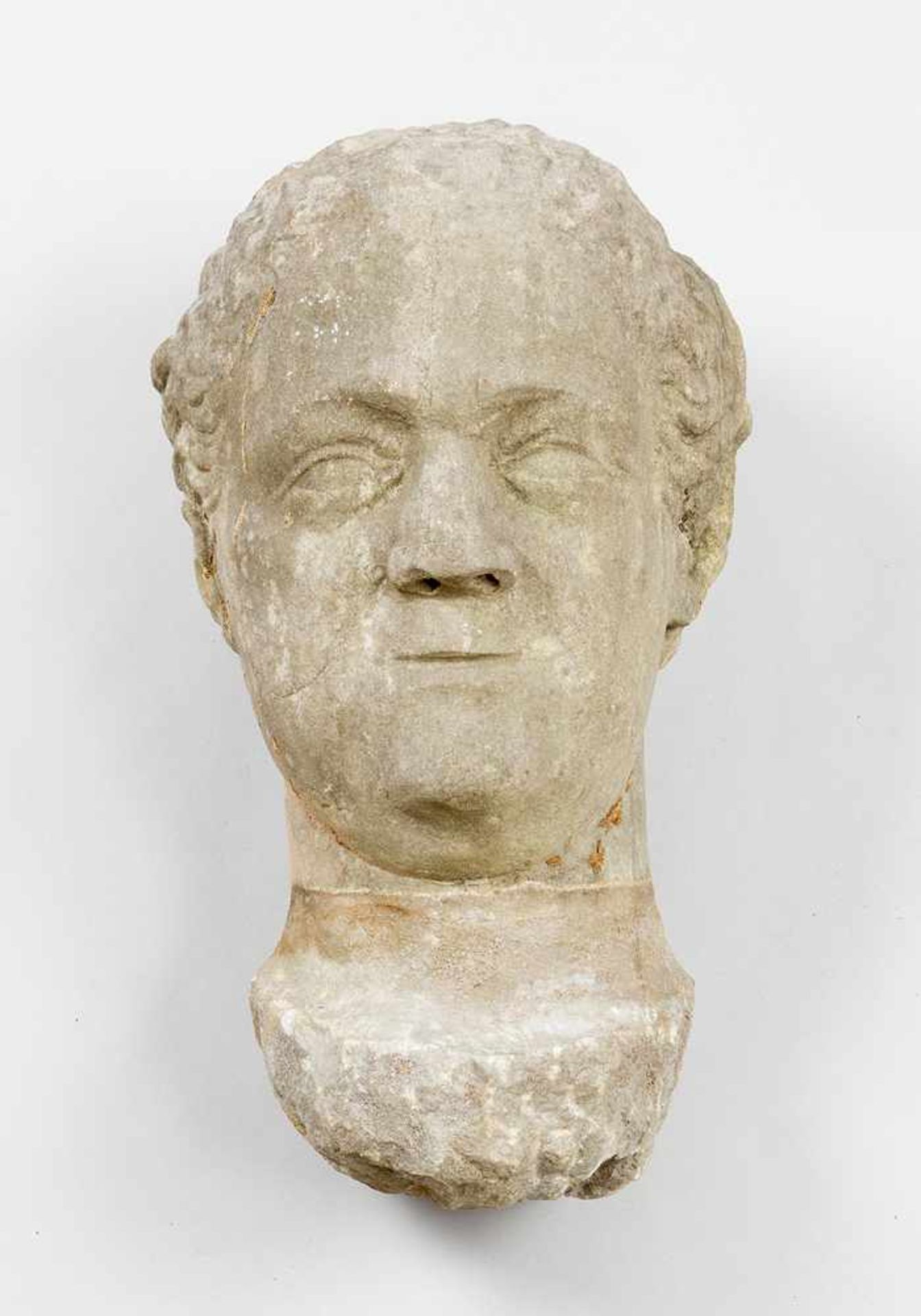 Baroque stone bust of a man with curled hair; grey stone with veins; weathered; possibly Austrian or