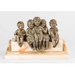 Demétre Chiparus (1886 – 1947), Five laughing children with puppet on a stone base; metal with