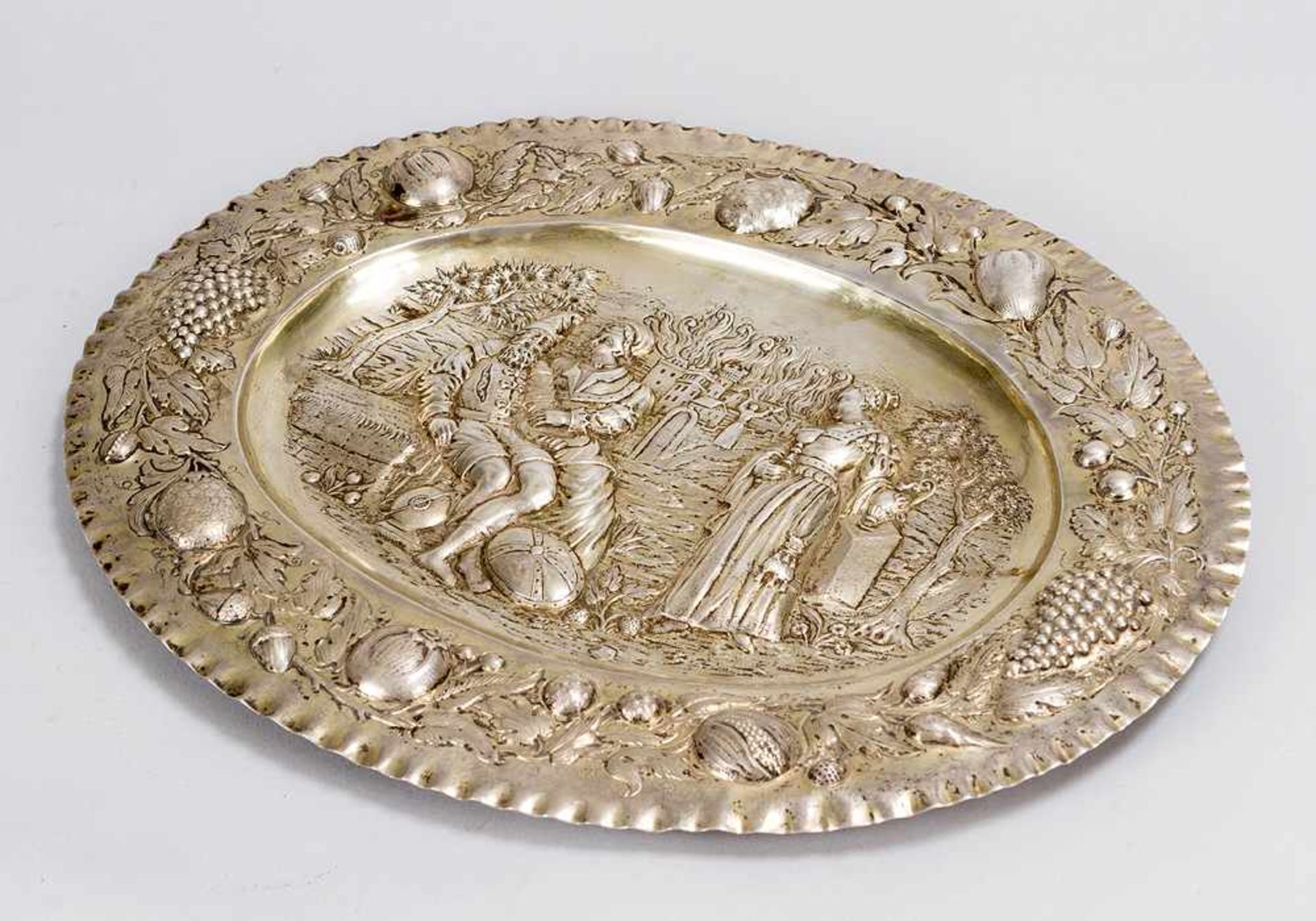 Baroque silver salver in oval shape, with waved border, decorated with fruits; in the centre Lot and