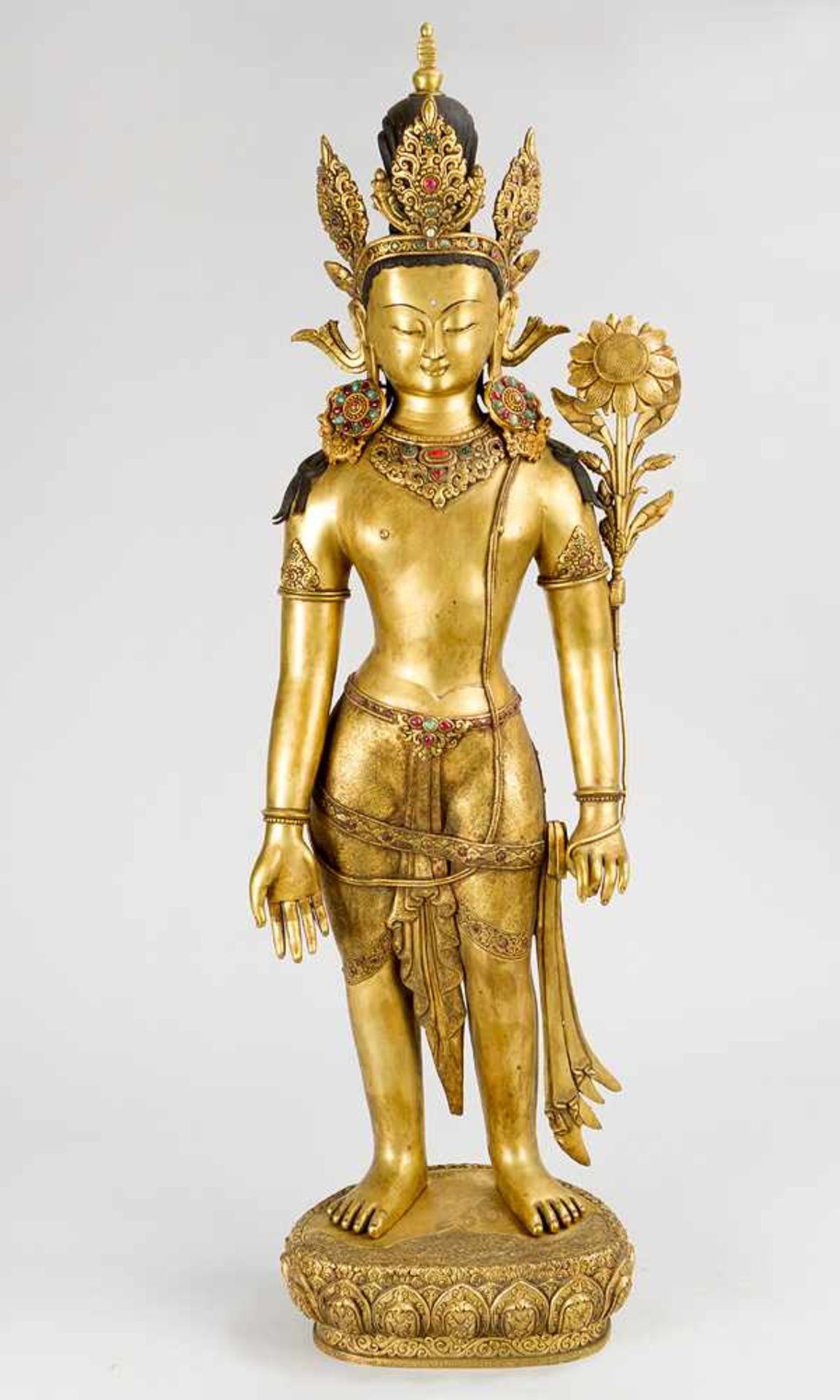 Standing Sitatara, with crown and lotus-flower, on top of her draped hair a small stupa, bronze cast
