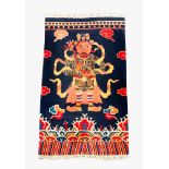 Tibet carpet of a warrior with ornaments in multicolours; on two sides fringes. 19/20th Century.