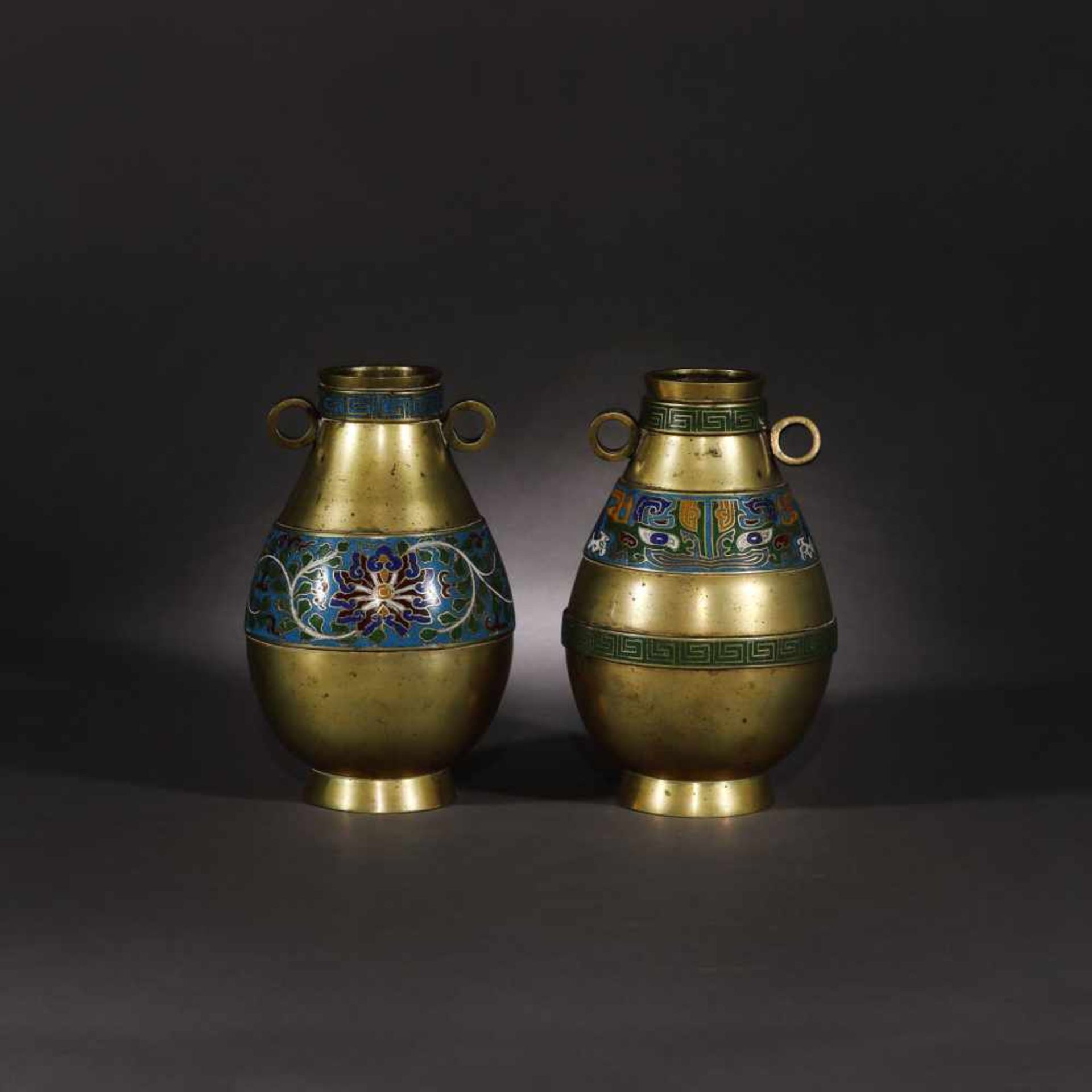 Two cloisonné vessels with vegetal motifs and the Taotie mask motif, bearing the retrospective