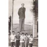 Young pioneers holding the "Little Red Book" next to an impressive board of Mao Zedong, the Cultural