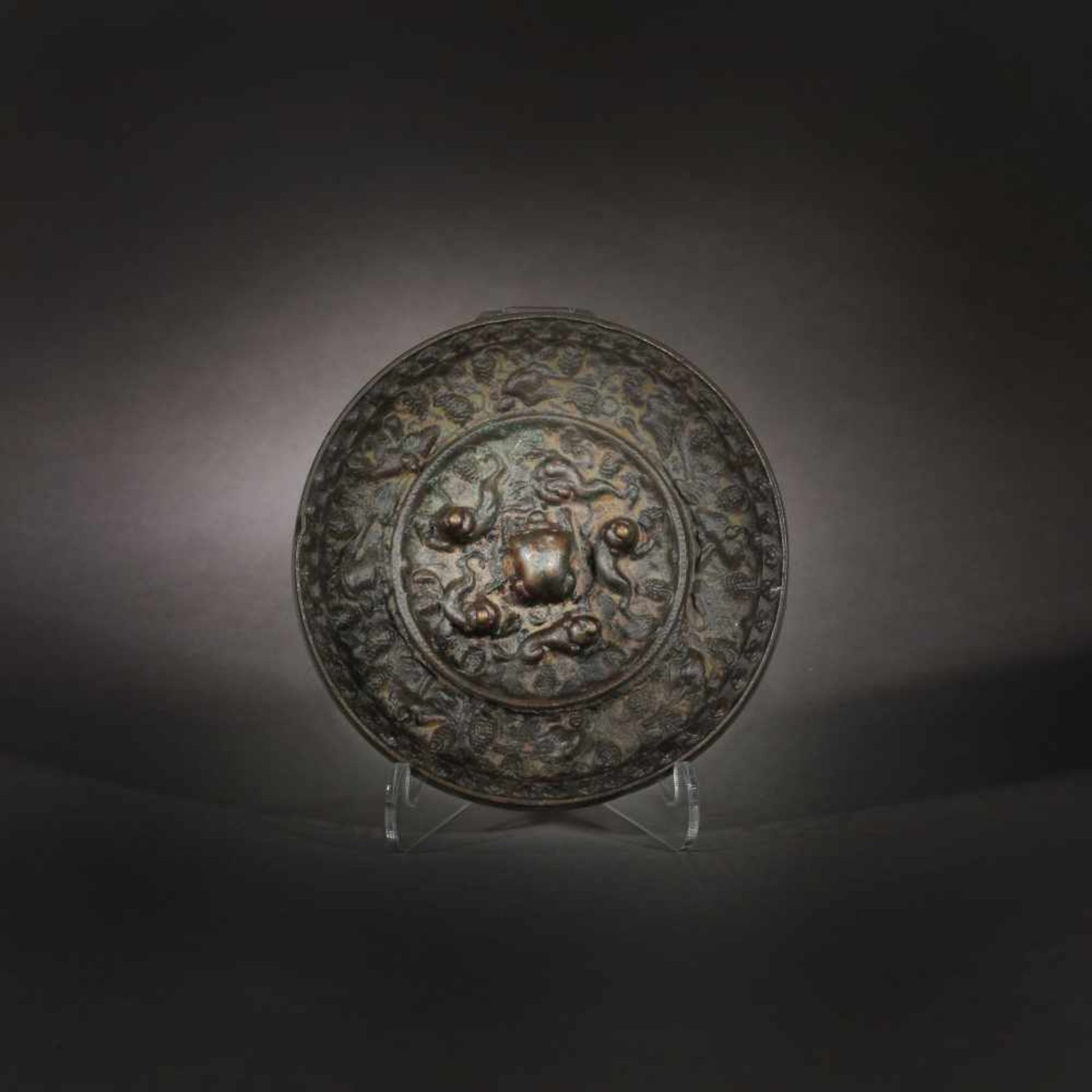 Patinated bronze mirror decorated with grapes, Pheonix birds surrounding a line of Chilong