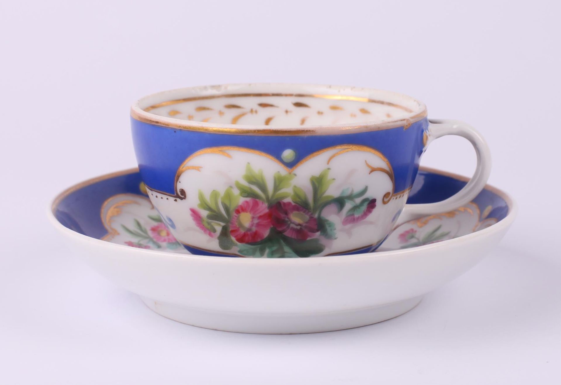 Tea cup and saucer set with floral painting. Russia. 1890s. Porcelain, painting, gilding. Cup: 5x8