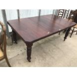 A VICTORIAN MAHOGANY WIND OUT DINING TABLE WITH EXTRA LEAF AND HANDLE