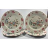 A SET OF FOUR 18TH CENTURY CHINESE CIRCULAR PLATES, ALL WITH FLORAL BORDERS AND FIGURES IN OUTDOOR