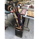 A VINTAGE WOODEN RACK WITH VARIOUS UMBRELLAS ETC