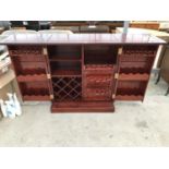 AN UNUSUAL FOLD OUT MAHOGANY COCKTAIL CABINET