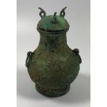 AN UNUSUAL ORIENTAL METAL LIDDED URN PENDANT