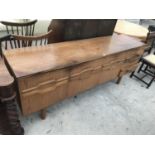 A RETRO TEAK SIDEBOARD WITH THREE DOORS AND THREE DRAWERS - WIDTH 183 CM