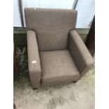 A BROWN FABRIC ARMCHAIR