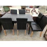 A BLACK DINING TABLE AND SIX LEATHERETTE DINING CHAIRS