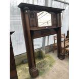 A VICTORIAN CARVED MAHOGANY FIRE SURROUND WITH OVER MANTLE AND BEVEL EDGE MIRROR