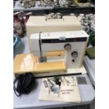 A CASED 'RICCAR' 9600 SEWING MACHINE