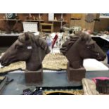 A PAIR OF HEAVY CAST METAL HORSES HEADS