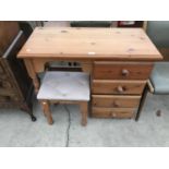 A PINE DRESSING TABLE WITH FOUR DRAWERS AND DRESSING STOOL