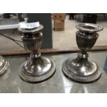 A PAIR OF HALLMARKED SILVER CANDLESTICKS WITH FLUTED DESIGN, WEIGHT BASES, HEIGHT 10.5CM