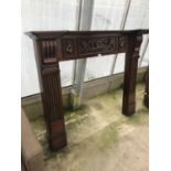 A CARVED MAHOGANY FIRE SURROUND