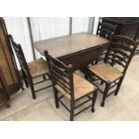 AN OAK DROP LEAF DINING TABLE AND FOUR OAK LADDER BACK DINING CHAIRS WITH RUSH SEATS