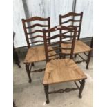 THREE OAK LADDER BACK DINING CHAIRS WITH RUSH SEATS