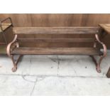 A HARDWOOD BENCH WITH CAST IRON ENDS 193CM LONG