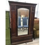 AN OAK WARDROBE WITH BEVEL EDGE MIRRORED DOOR AND ONE DRAWER