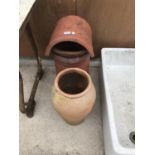 A CHIMNEY POT WITH COWL 64CM HIGH AND A TERRACOTTA URN 49CM HIGH