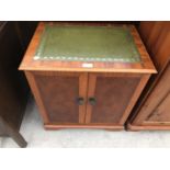 A MAHOGANY CABINET WITH TWO DOORS AND GREEN LEATHER TOP