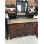 AN OAK DRESSING TABLE WITH TWO LONG, TWO SHORT AND TWO SMALL DRAWERS AND BEVEL EDGE MIRROR