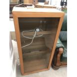 A TEAK CABINET WITH SINGLE DOOR