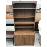 A TEAK EFFECT CABINET WITH TWO DOORS AND UPPER SHELVING