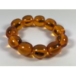 AN UNUSUAL AMBER TYPE BEAD 'INSECT' BRACELET