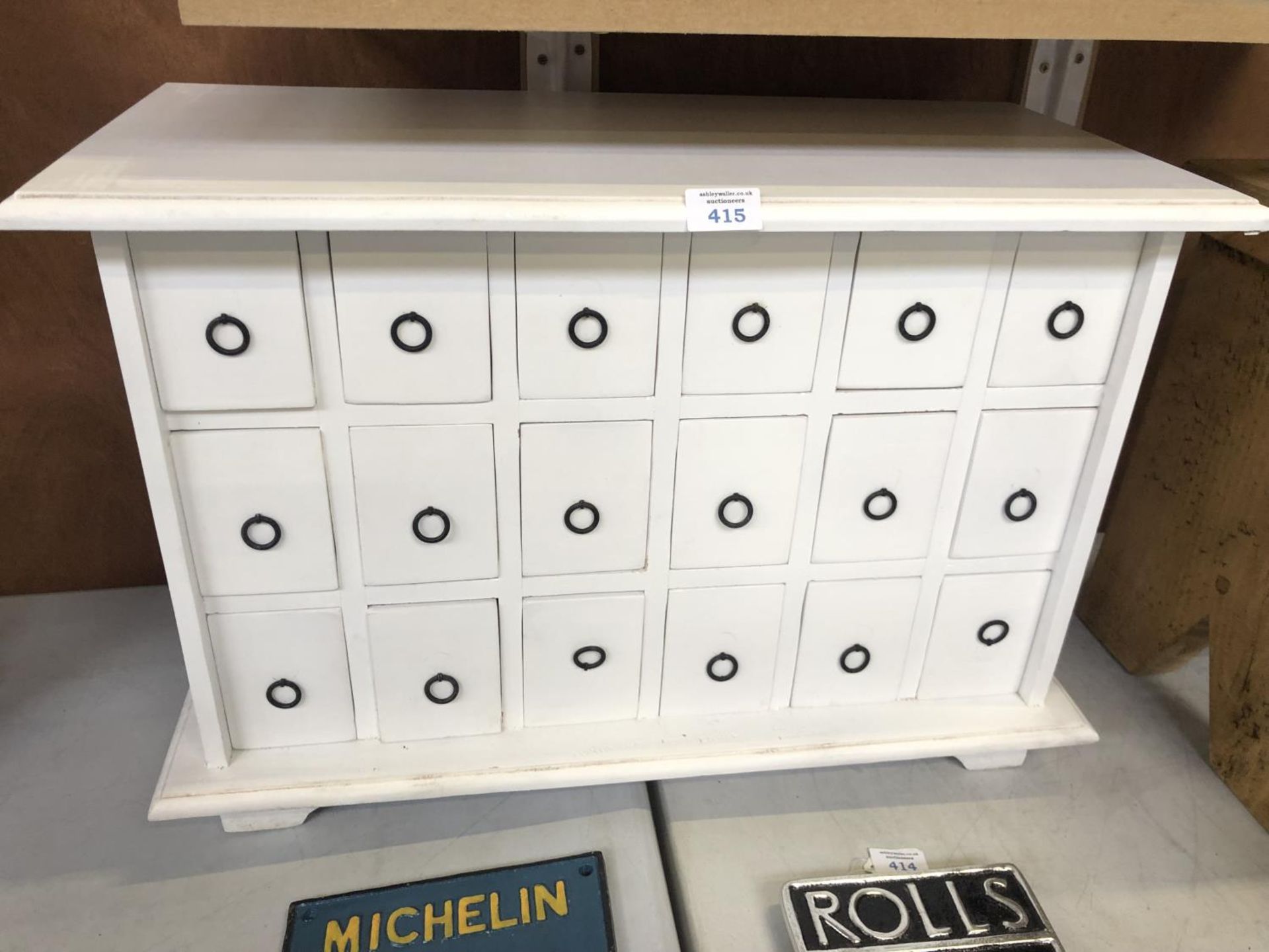 A WHITE PAINTED WOODEN EIGHTEEN DRAWER SPICE CABINET