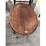 AN OVAL MAHOGANY COFFEE TABLE