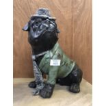 A MODEL OF A SITTING BULL DOG WITH HAT AND TIE