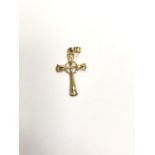 A LADIES ORNATE, STAMPED 14CT YELLOW GOLD CROSS PENDANT