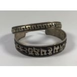 TWO CHINESE WHITE METAL BRACELETS WITH DRAGON DESIGN INNER TO ONE