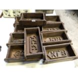 A SET OF TEN WOODEN BRICK MOULDS