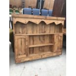 A PINE PLATE RACK WITH TWO DOORS AND FOUR DRAWERS