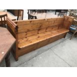 A PITCH PINE CHURCH PEW - WIDTH 222 CM