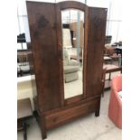 AN OAK WARDROBE WITH BEVEL EDGE MIRRORED DOOR AND ONE DRAWER