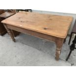 A PINE DINING TABLE ON TURNED SUPPORTS